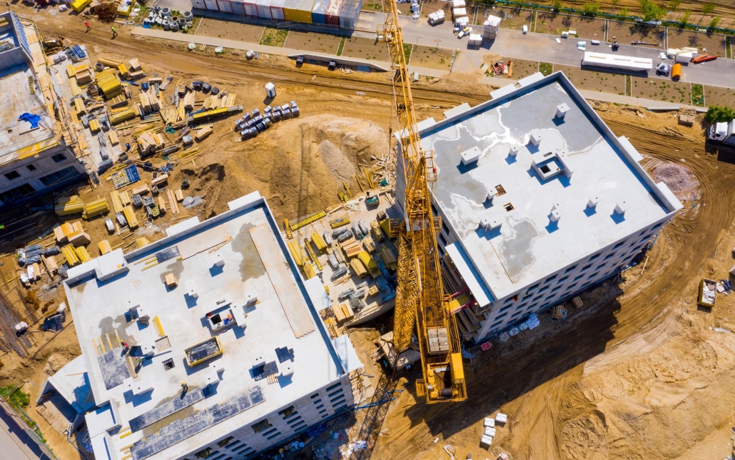 Overhead view of a large construction site with crane